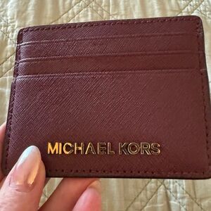 Michael Kors card holder in maroon. With ID slot excellent condition!